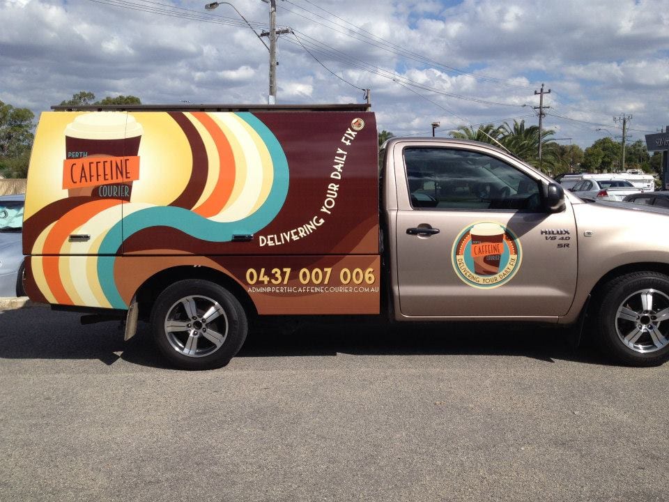 Vehicle driving in Perth with fleet decals